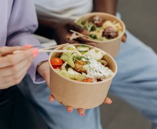 Two People Eating Healthy Food In Bowls