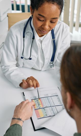 A Medical Practitioner Showing a Patient Paper